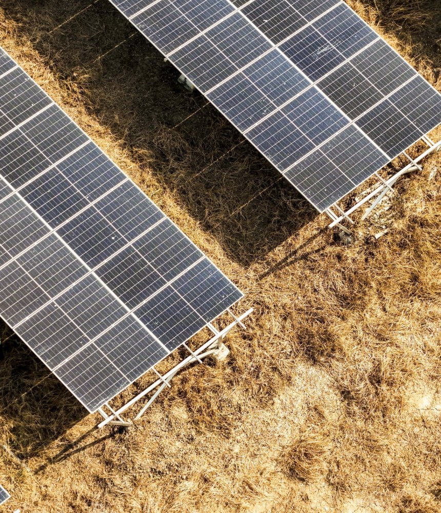 aerial-view-of-solar-panels-between-two-large-wate-2025-06-05-14-52-31-utc-min